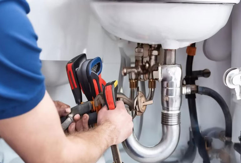 Professional Plumber working on a sink in Sunny Isles Beach FL